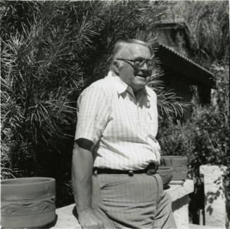Unidentified Gray Haired Man Leaning On Fence