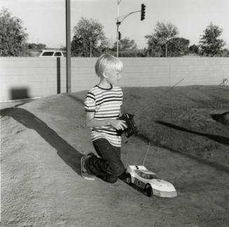 Unidentified Boy with Remote Control (RC) Car