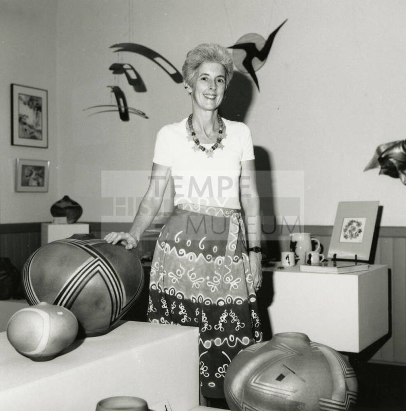 Unidentified Woman Standing Amid Pottery & Pots