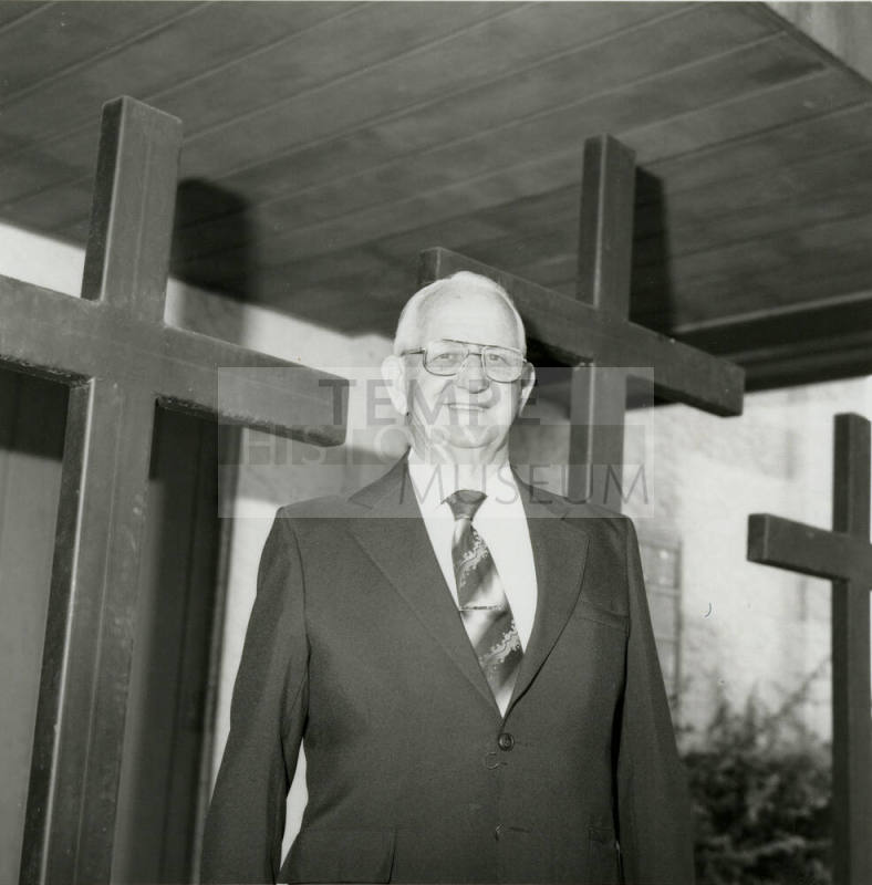 Unidentified Man Stands In Front of 3 Crosses