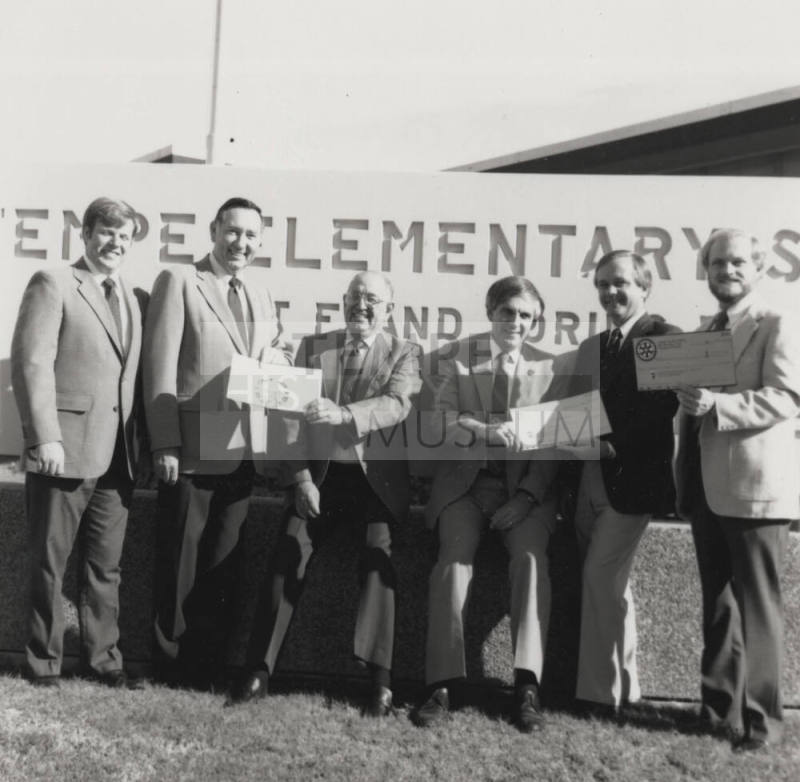 Group of men in front of a Tempe Elementary School sign