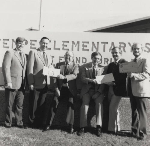 Group of men in front of a Tempe Elementary School sign