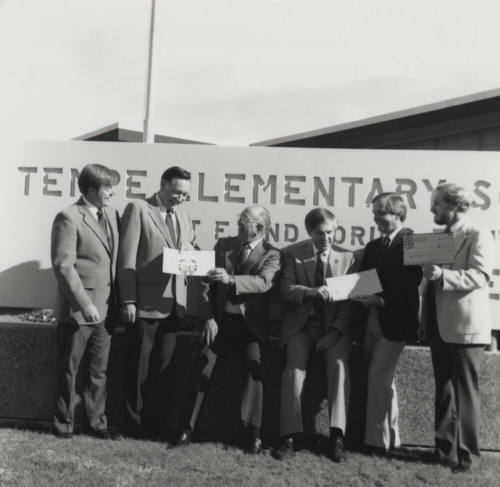 Group of men in front of a Tempe Elementary School sign
