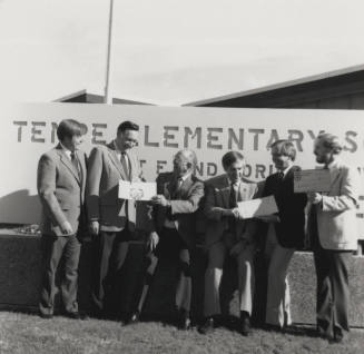 Group of men in front of a Tempe Elementary School sign