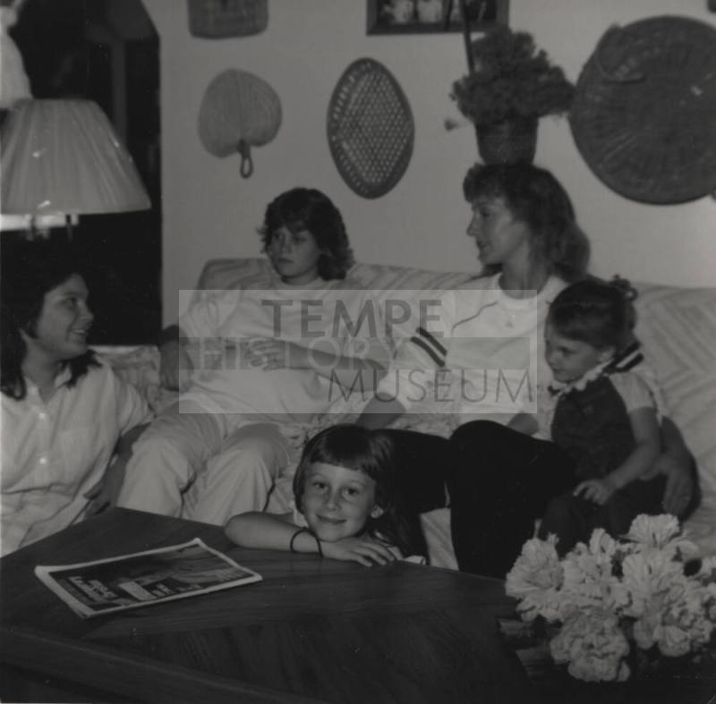 Family sits in their living room