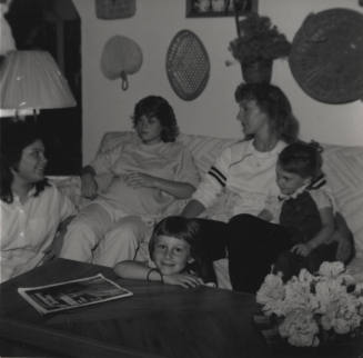 Family sits in their living room