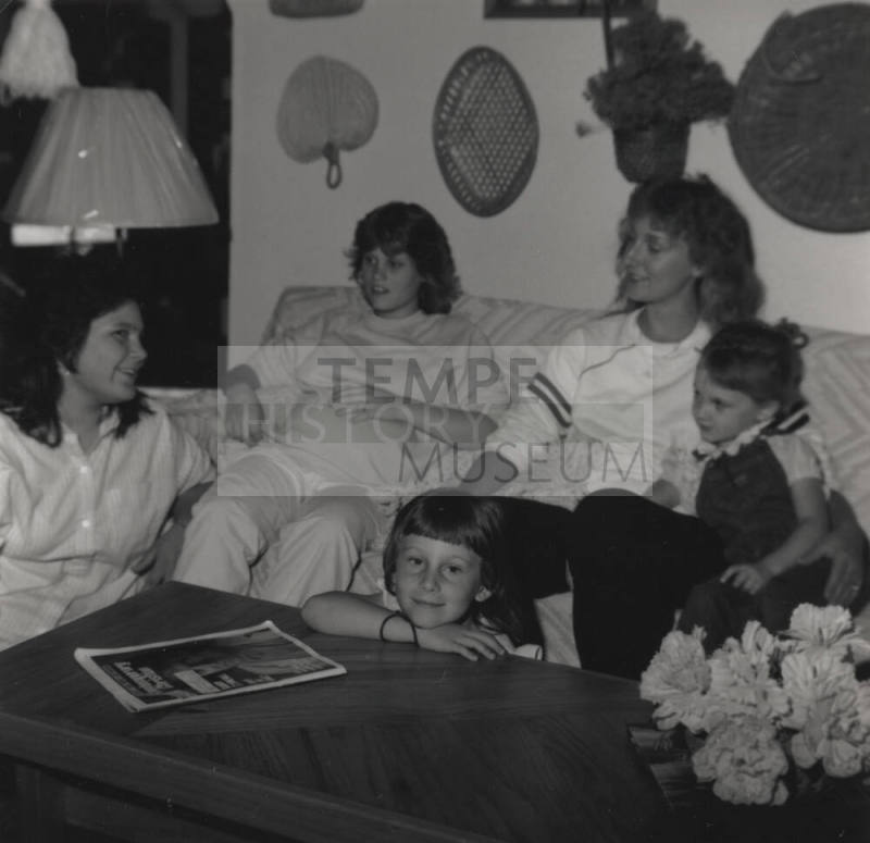 Family sits in their living room