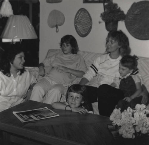 Family sits in their living room