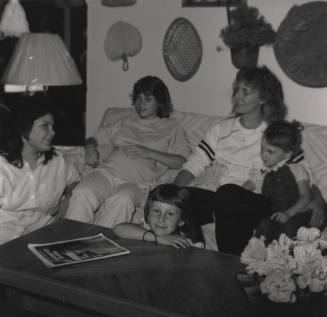 Family sits in their living room