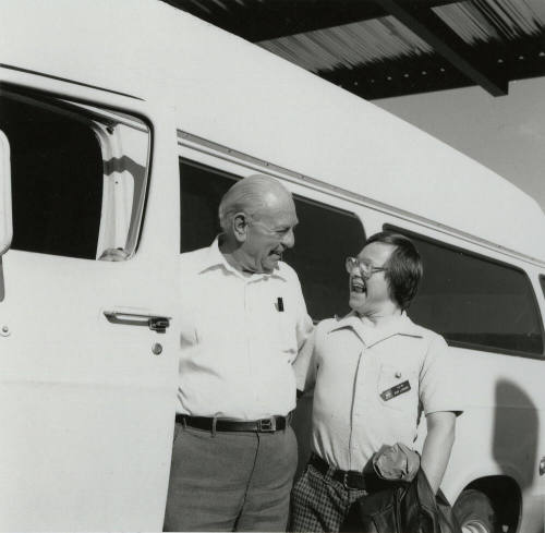 Men standing next to a van. - December 1985