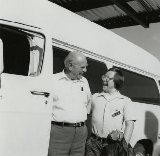 Men standing next to a van. - December 1985