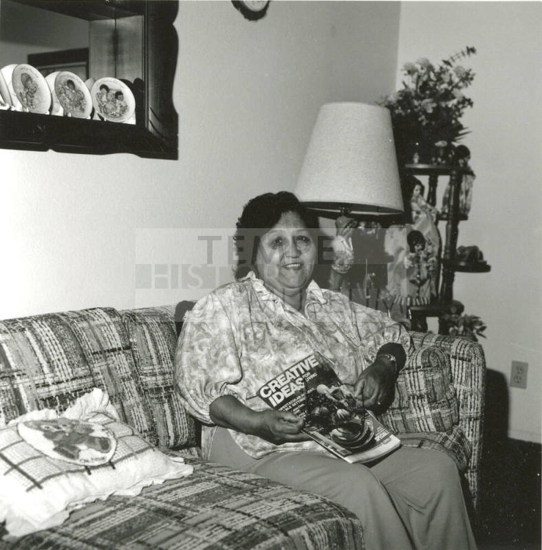 Woman poses on couch with Creative Ideas magazine