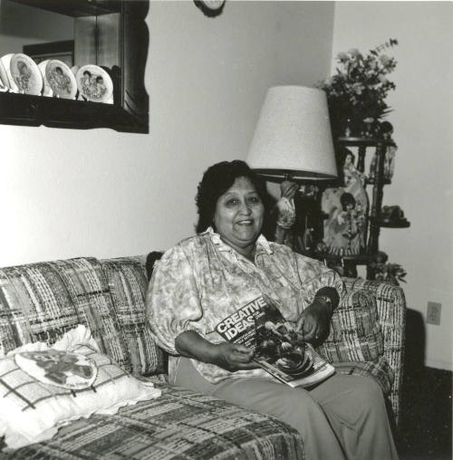 Woman poses on couch with Creative Ideas magazine