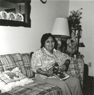 Woman poses on couch with Creative Ideas magazine