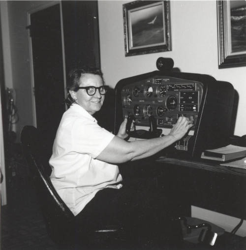Woman in glasses in front of a machine