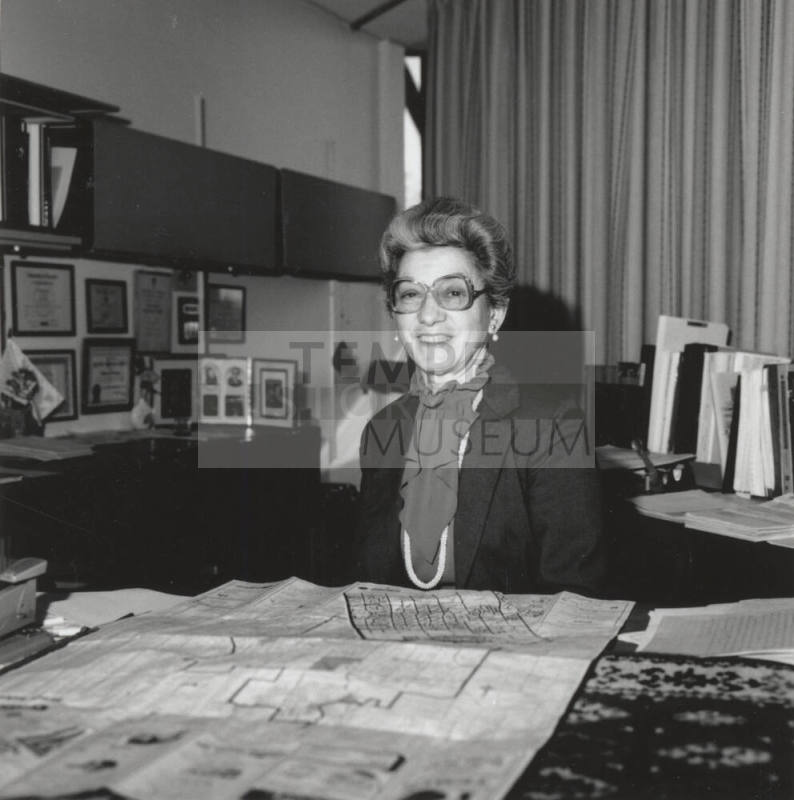 Virginia Thompson Behind Desk Studying Maps - (1 of 2)