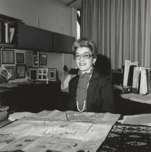 Virginia Thompson Behind Desk Studying Maps - (1 of 2)