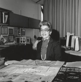 Virginia Thompson Behind Desk Studying Maps - (1 of 2)