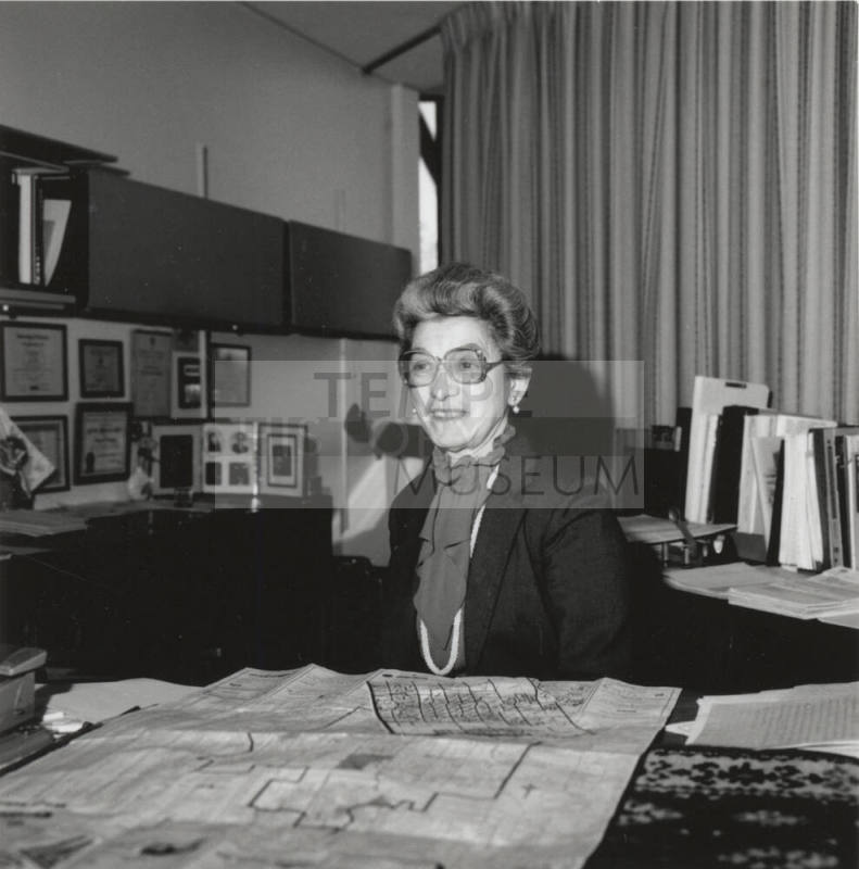 Virginia Thompson Behind Desk Studying Maps - (2 of 2)