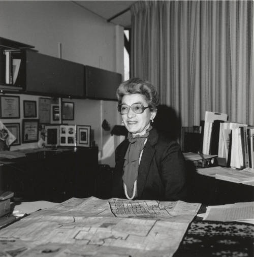 Virginia Thompson Behind Desk Studying Maps - (2 of 2)