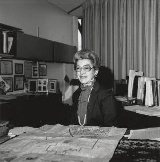Virginia Thompson Behind Desk Studying Maps - (2 of 2)