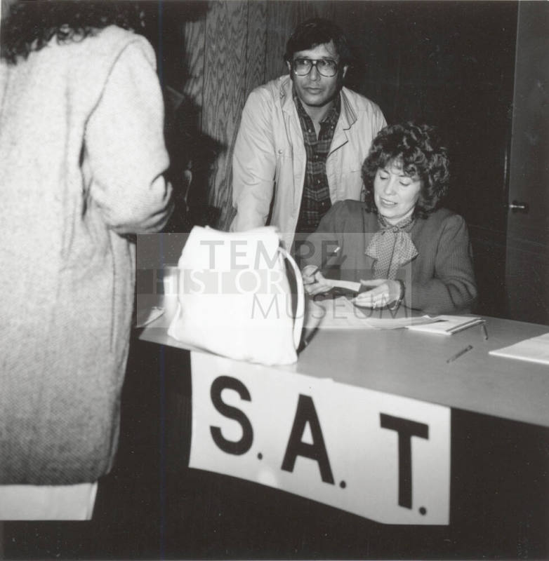 Unidentified People working an S.A.T. (Scholastic Aptitude Test?) table