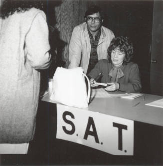 Unidentified People working an S.A.T. (Scholastic Aptitude Test?) table
