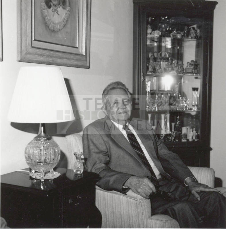 Unidentified Man seated in living room chair - (1 of 2)