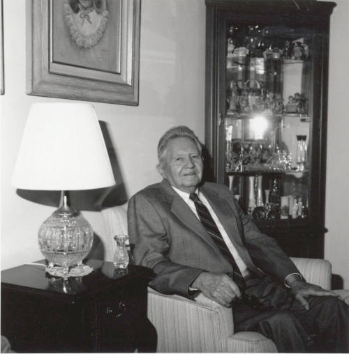 Unidentified Man seated in living room chair - (1 of 2)