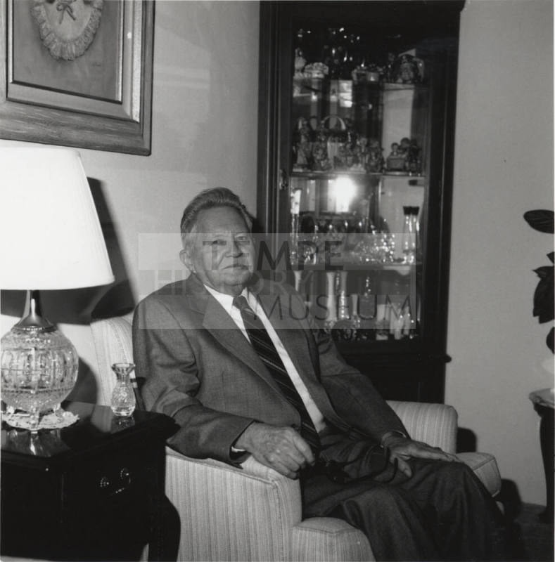 Unidentified Man seated in living room chair - (2 of 2)