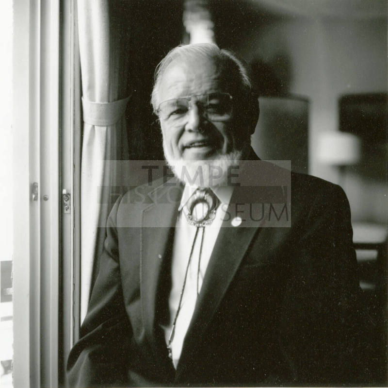 Portrait of an unknown man standing next to a window