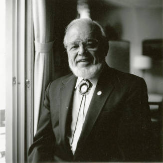Portrait of an unknown man standing next to a window