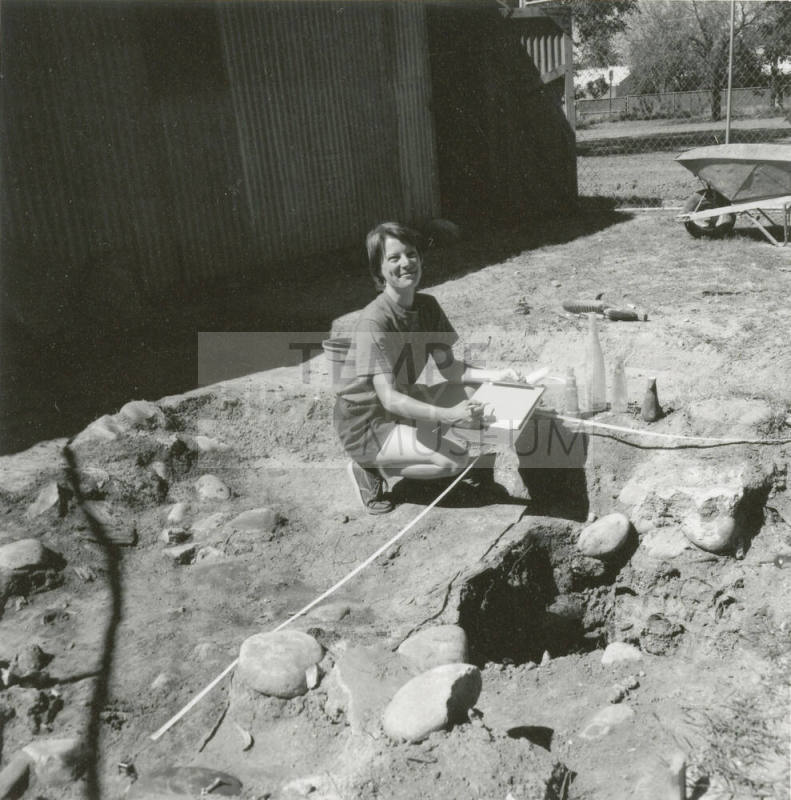 Woman excavates some old bottles
