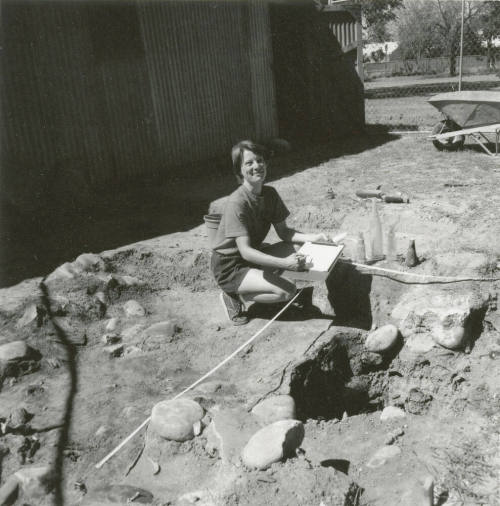 Woman excavates some old bottles
