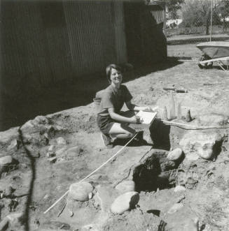 Woman excavates some old bottles