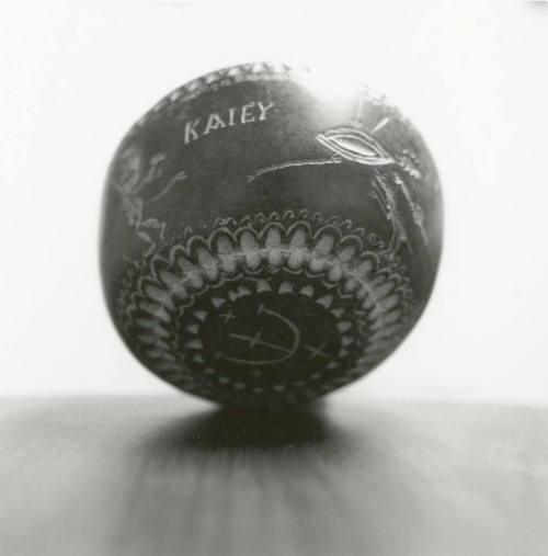 Hand holds small ceramic bowl reading "KAlEY"