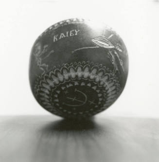 Hand holds small ceramic bowl reading "KAlEY"