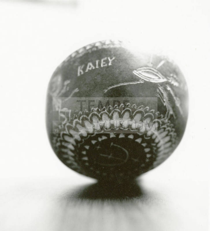 Hand holds small ceramic bowl reading "KAlEY"