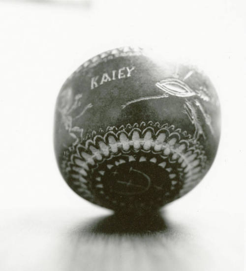Hand holds small ceramic bowl reading "KAlEY"