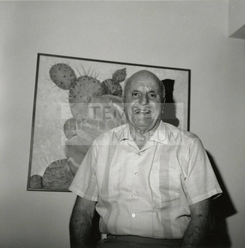 Older man in front of desert plant, cactus painting