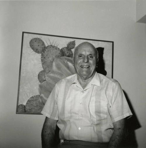 Older man in front of desert plant, cactus painting