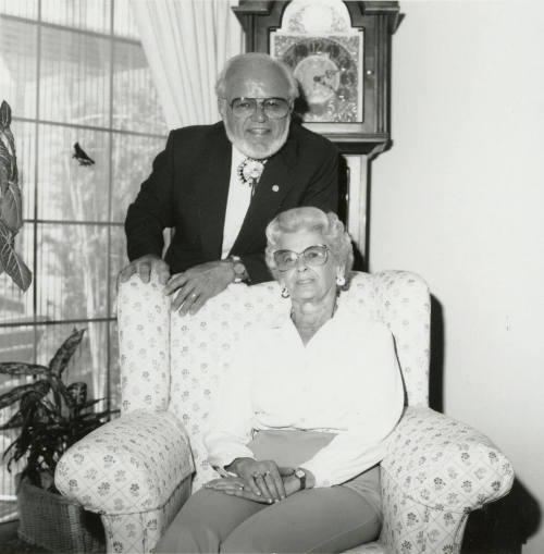 Older man and woman seated in living room