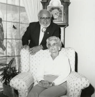 Older man and woman seated in living room