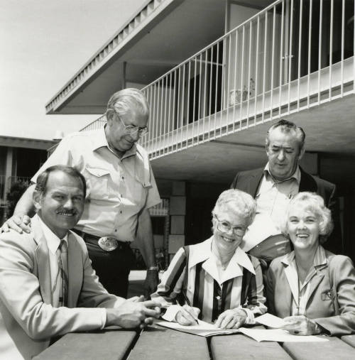 Unidentified Group of 3 Men & 2 Women Signing Papers