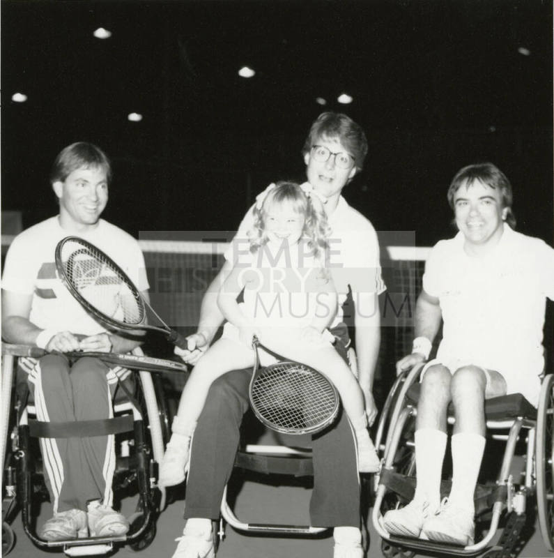 Unidentified Group of 3 wheel-chair-bound people, 1 holding tennis racquet & small girl with racquet