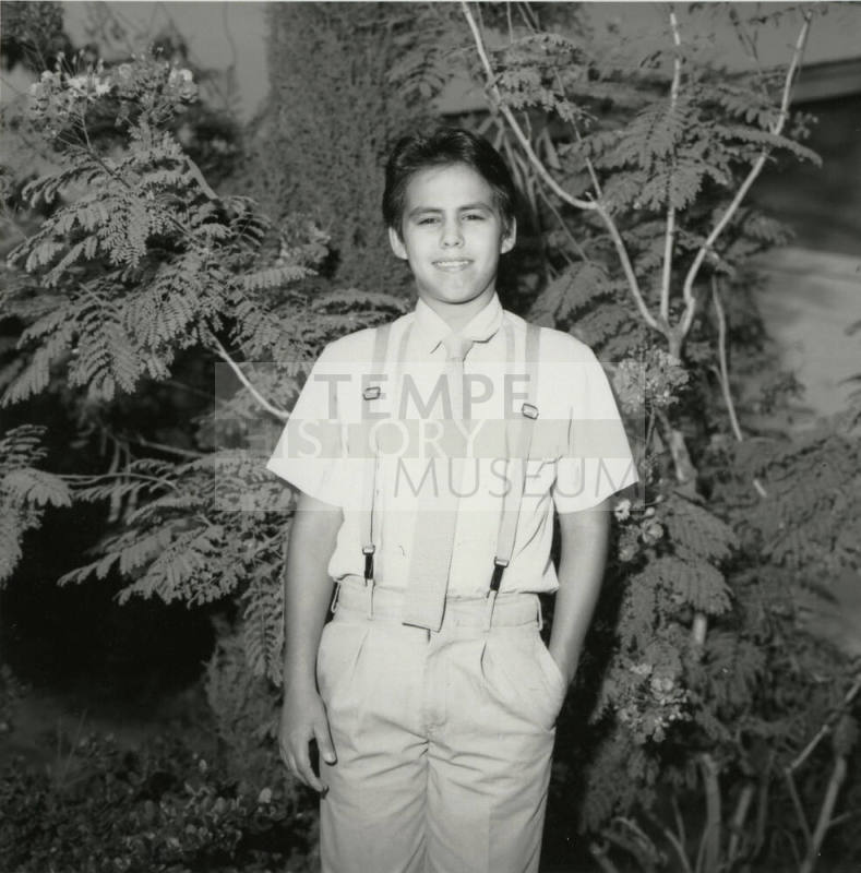 Unidentified Boy Stands In Front of Tree - (1 of 2)