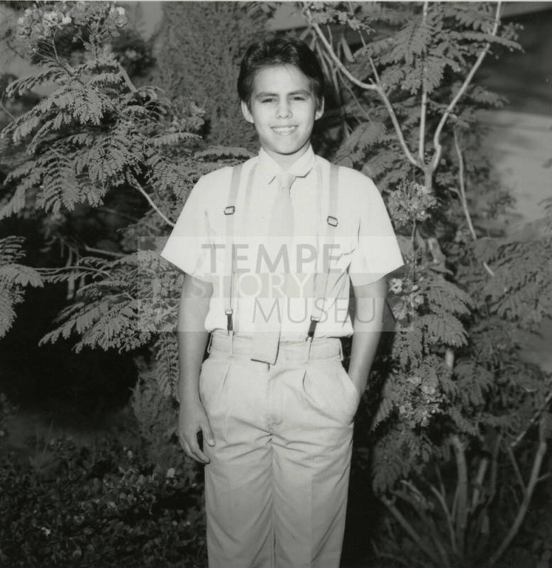 Unidentified Boy Stands In Front of Tree - (2 of 2)