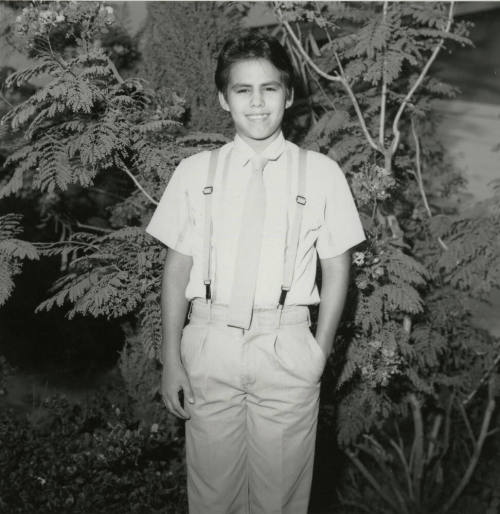Unidentified Boy Stands In Front of Tree - (2 of 2)
