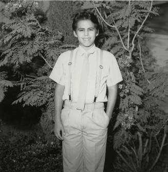 Unidentified Boy Stands In Front of Tree - (2 of 2)
