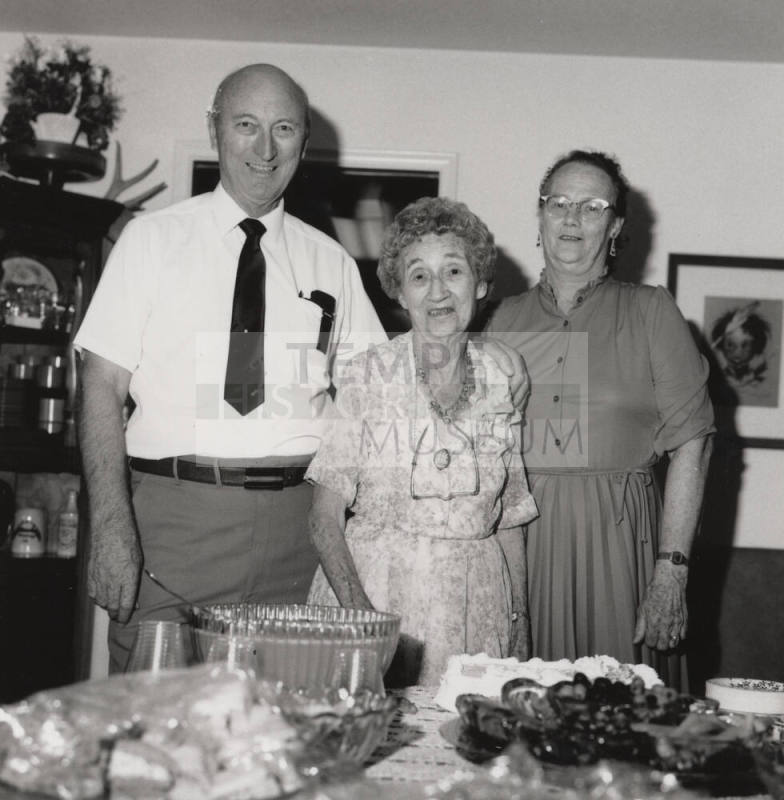 Unidentified Family standing by dinner table